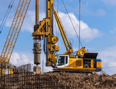 Yellow,Hydraulic,Drilling,Rig,On,A,High-rise,Building,Construction,Site.